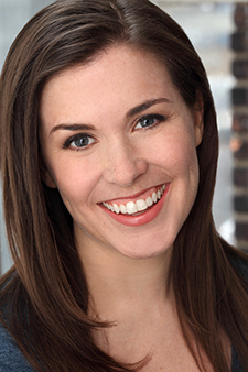 "portrait of a woman with long brown hair and big smile"